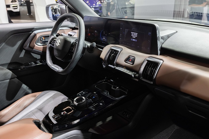 座艙設計以科技感與 SUV 機能風格並重，整合式顯示系統（IDS）將 10.25 吋數位儀表 與 10.1 吋中控觸控螢幕 視覺整合，支援無線 Apple CarPlay 與 Android Auto。圖／SUZUKI 提供